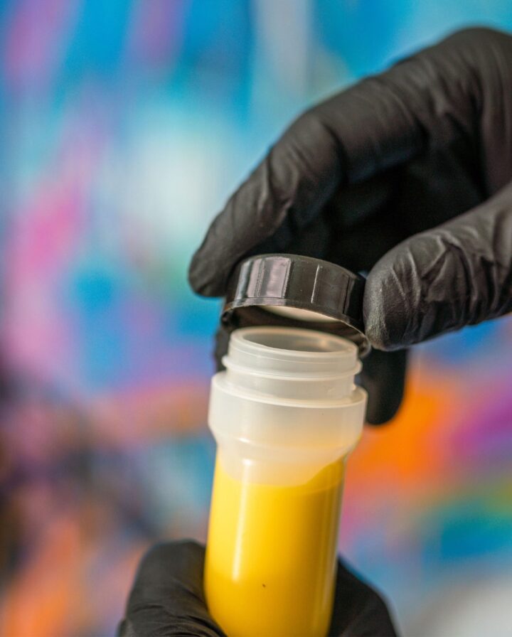 Photo showing a Dripstick marker filled with yellow permanent paint being closed by a screw cap.